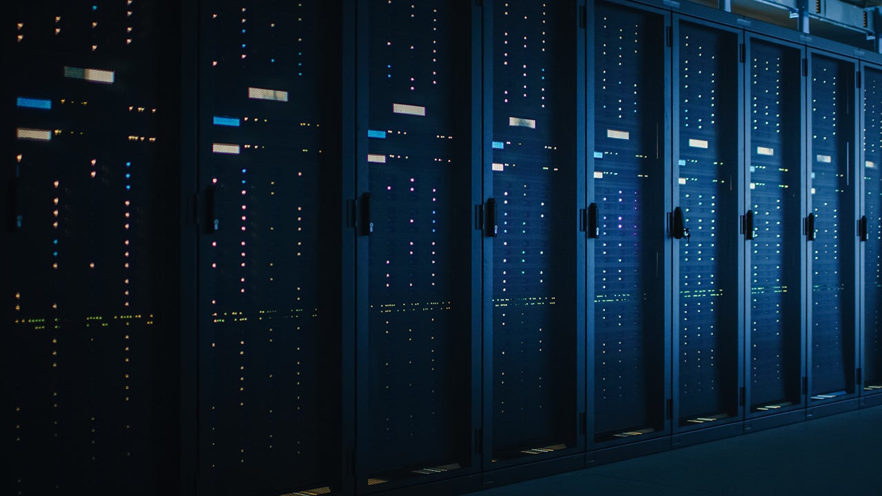 Shot of Dark Data Center With Multiple Rows of Fully Operational Server Racks. Modern Telecommunications, Cloud Computing, Artificial Intelligence, Database, Supercomputer.